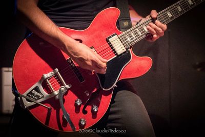 Close-up of man playing guitar