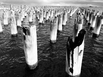 Wooden posts in sea