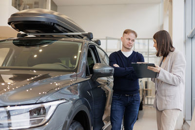 Side view of business colleagues working on road