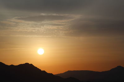 Scenic view of silhouette mountains against sky during sunset