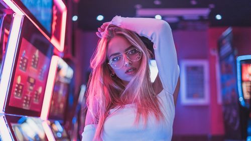 Portrait of young woman wearing eyeglasses in room