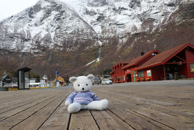 Toy car on snow covered mountain against buildings