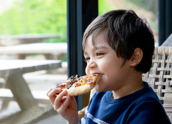 Portrait of boy eating food