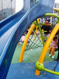 Low angle view of children playing on playground