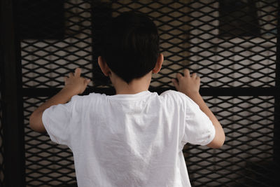 Portrait of boy in a fence