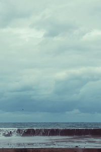 Scenic view of sea against cloudy sky