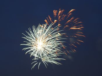 Sky illumed with fire crackers against clear blue sky