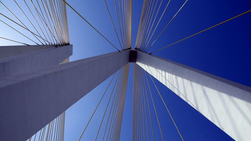 Low angle view of cables against blue sky