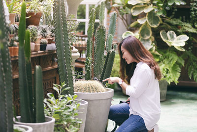 Woman sitting by plants