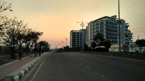 Empty road with buildings in background
