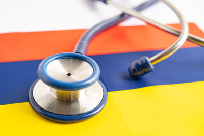 Close-up of stethoscope on blue background