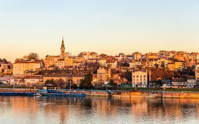 River in city against clear sky