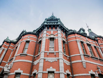 Low angle view of red building against sky