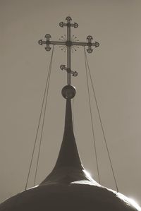 Low angle view of cross against sky