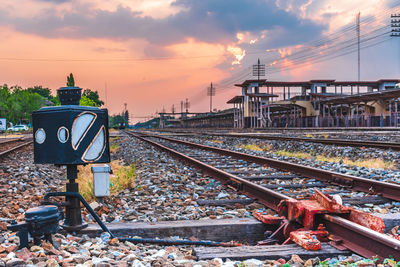 Railroad tracks against sky during sunset