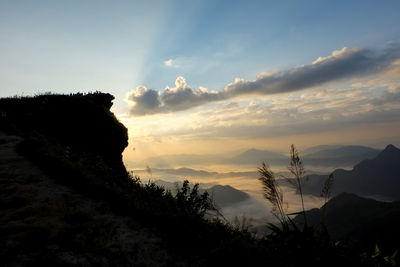 Scenic view of silhouette mountains against sky at sunset