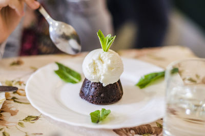 Cropped image of person having dessert on table