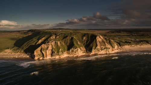 Scenic view of mountains and sea against sky