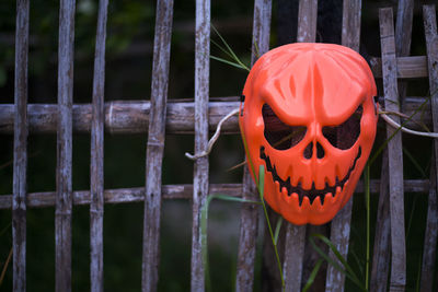 Close-up of pumpkin on metal fence during halloween