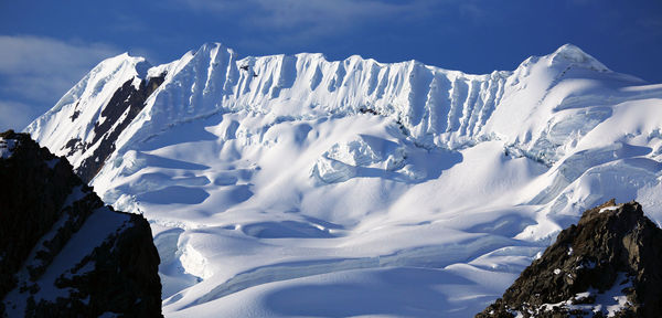 View of snowcapped mountains against blue sky