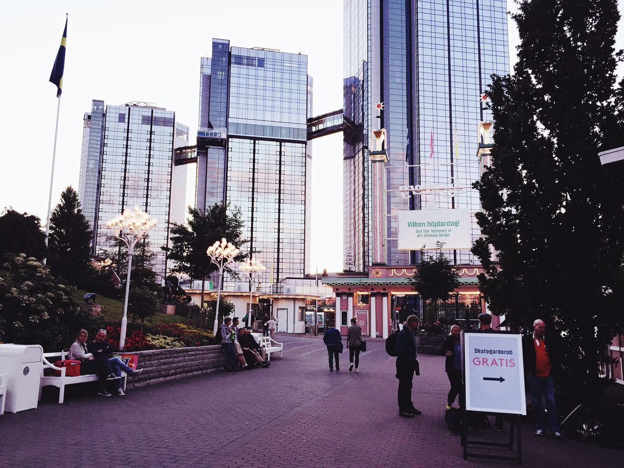 city, building exterior, growth, built structure, architecture, outdoors, tree, real people, day, skyscraper, sky, people