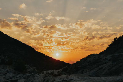 Scenic view of silhouette mountains against sky during sunset