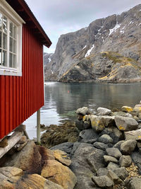 Scenic view of lake by buildings against sky