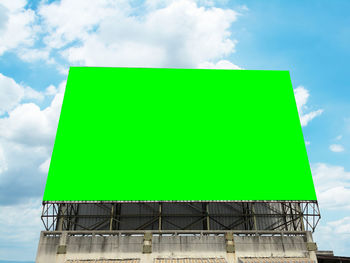 Low angle view of road sign against sky