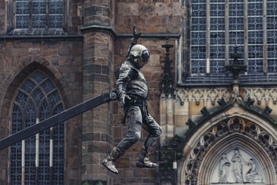 Low angle view of statue against building in city