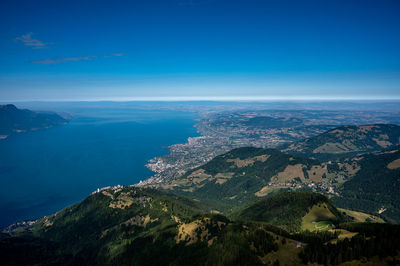 High angle view of townscape by sea against sky