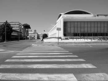 People crossing road against buildings in city