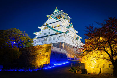 Low angle view of illuminated building against sky at night