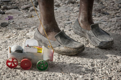 Low section of man wearing messy shoes on ground