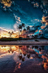 Scenic view of lake against sky at sunset