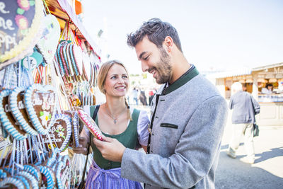 Young couple standing at market stall