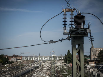 Railroad tracks against sky in city