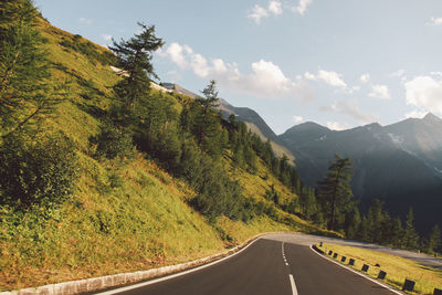 Empty road by mountains