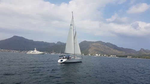 Sailboat sailing on sea against sky
