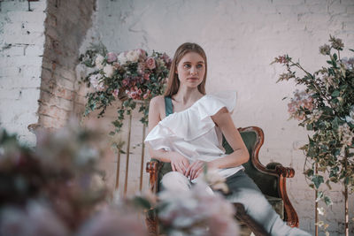 Portrait of a smiling young woman sitting outdoors