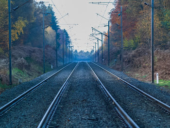 Surface level of railroad tracks against sky