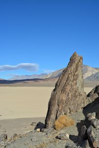 Scenic view of desert against blue sky, the grandstand on the racetrack playa