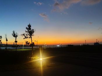 Scenic view of silhouette street against sky during sunset