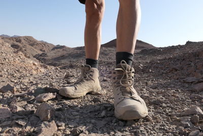 Senior man wearing shoes in the desert 