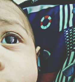 Cropped image of baby looking away