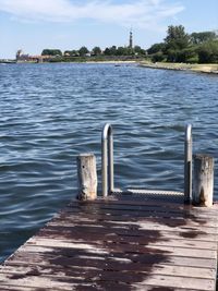 Pier over lake against sky