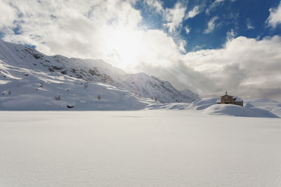 Scenic view of snow covered mountains against sky