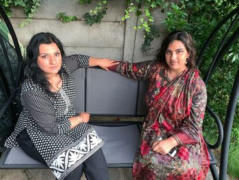 Portrait of women sitting on swing