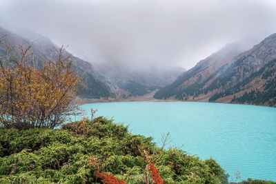 Scenic view of lake and mountains against sky