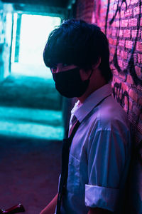 Side view portrait of boy looking down