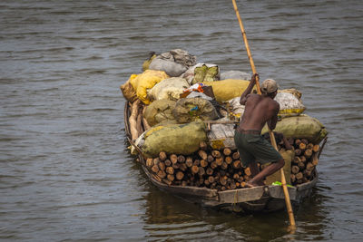 Rear view of man fishing in sea